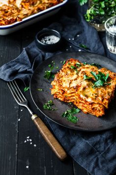 a slice of lasagna on a plate with parsley