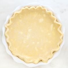 an uncooked pie crust in a white bowl