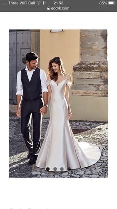 a man and woman are walking down the street in wedding dresses, with one holding the other's hand