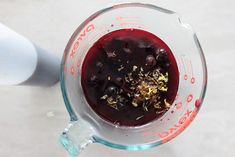 a blender filled with berries and gold flakes