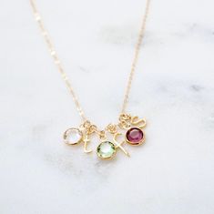 "Personalized Birthstone Initial Necklace - Birthstone Necklace, Mommy Necklace, Gift for Grandma, Family Initials Necklace, Children's initial necklace Make this necklace uniquely yours by customizing the initials and birthstones of the most important people in your life. An adorable necklace that is perfect to wear everyday. Get it for yourself or give it to someone special for a thoughtful personal gift. Features: ------------- - gold plated letters (lowercase only) - 14K gold filled chain - Birthstone Necklace For Grandma, Dainty Personalized Necklace For May Birthstone, Personalized Dainty Necklace With May Birthstone, May Birthstone Charms Necklace As Gift, Elegant Name Necklace With Charms For Birthday, Initial Pendant Necklace For May Birthstone Gift, Charm Necklace For Mom With May Birthstone, Personalized Gemstone Necklace For May Birthstone, Elegant Handmade Birthstone Necklace For Mother's Day