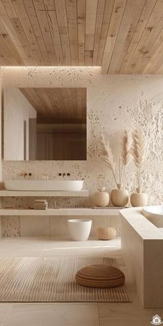 a modern bathroom with white fixtures and wood ceilinging, along with two sinks on either side of the bathtub