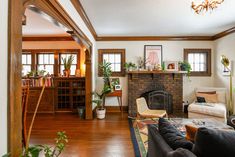 a living room filled with furniture and a fire place