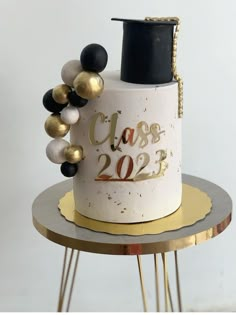 a graduation cake with gold and black decorations