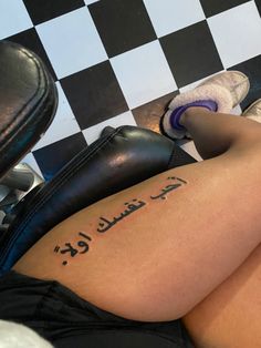 a woman laying on top of a black and white checkered floor