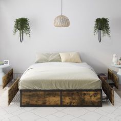 a bed sitting next to two planters on either side of the bed in a white room