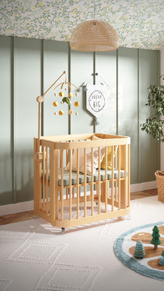 a baby's room with a crib, rocking chair and potted plant