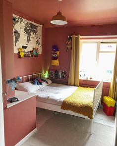 a bedroom with pink walls and yellow curtains on the windowsills is pictured in this image