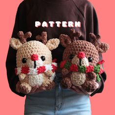 two crocheted stuffed animals are held in front of a woman's torso