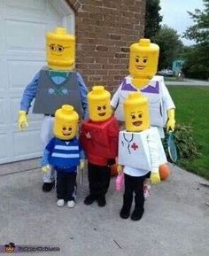 three people in lego costumes standing next to each other