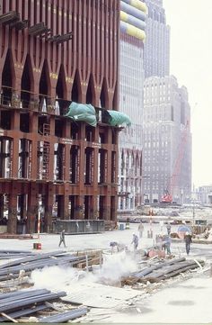 construction workers are working on the side of a building