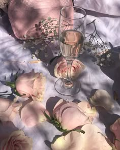 an image of flowers on the table with wine glasses and other things to do in bed