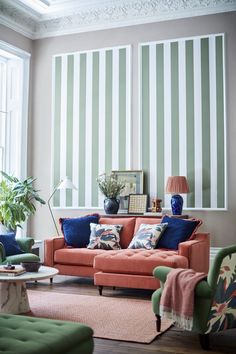 a living room filled with furniture and striped walls