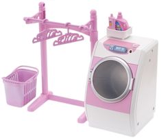 a pink and white toy washing machine next to a laundry basket