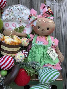 a teddy bear sitting on top of a wooden bench next to other stuffed animals and decorations