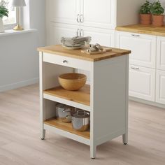 a kitchen island with wooden top and drawers