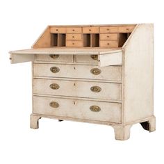 an old wooden desk with drawers on the top and bottom drawer open to reveal several compartments