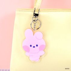 a pink keychain with a small cartoon character on it's front pocket