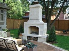 a fire place sitting in the middle of a backyard