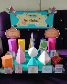 an assortment of colorful paper toys sitting on top of a purple chair