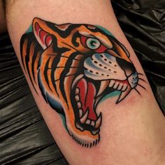 a colorful tiger tattoo on the leg