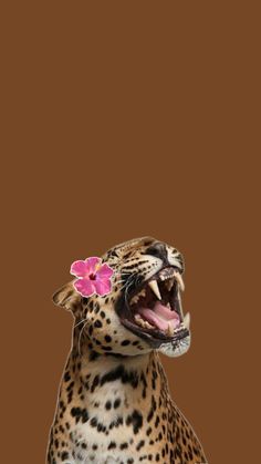 a leopard with its mouth open and flowers in it's hair