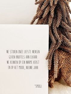 a card with a quote on it next to a plant