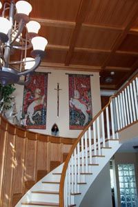 the inside of a house with stairs and chandelier hanging from it's ceiling