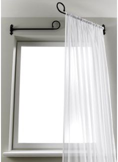 a white curtain hanging in front of a window