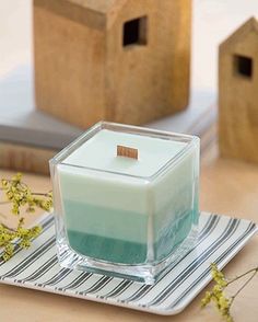 a square candle sitting on top of a plate