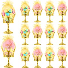 twelve golden vases with pink flowers on them