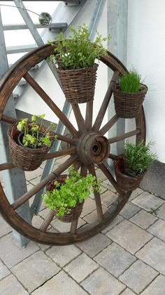 an old wagon wheel with plants in it