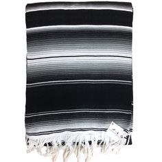 a black and white striped blanket with fringes