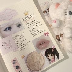 an open book with pictures and stickers on the pages next to a stuffed animal