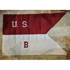 a red and white flag with the u s b on it hanging from a wall