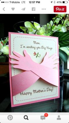 a mothers day card on a table with flowers