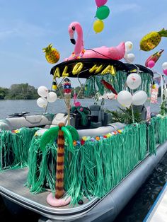 a boat decorated with decorations and balloons on the water