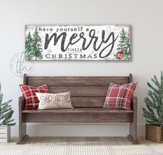 a wooden bench sitting in front of a christmas sign