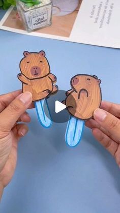 two people holding up wooden cutouts with bears on them and one is holding a toothbrush