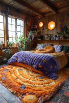 a bedroom with a large bed covered in purple and orange blankets on top of it