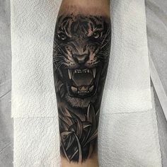 a man with a tiger tattoo on his leg