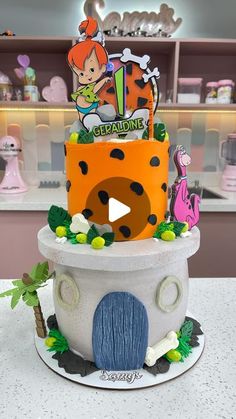 the cake is made to look like it has been decorated with cartoon characters and decorations