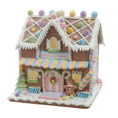 a close up of a gingerbread house on a white background