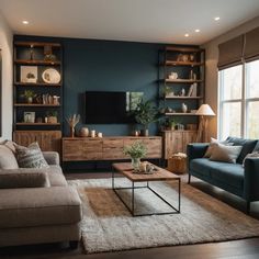 a living room filled with furniture and a flat screen tv mounted on a wall next to a window