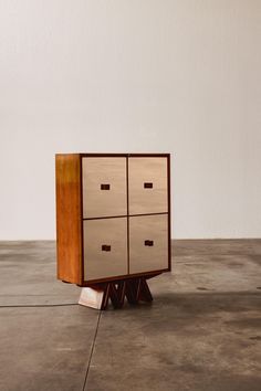 a wooden cabinet sitting on top of a cement floor