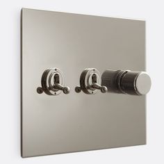 two knobs on the side of a wall mounted light switch