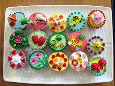 there are many cupcakes that have been decorated to look like flowers and fruit