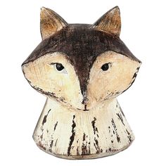 a wooden carving of a fox's head on a white background