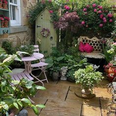 an outdoor garden with potted plants and chairs