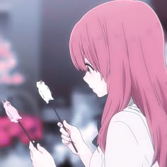 a girl with pink hair is holding a flower